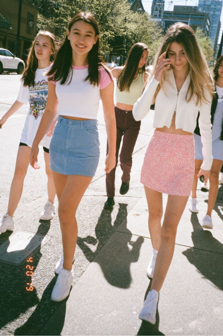 A group of girls walking together chatting in downtown Vancouver. Shot on 35mm film.