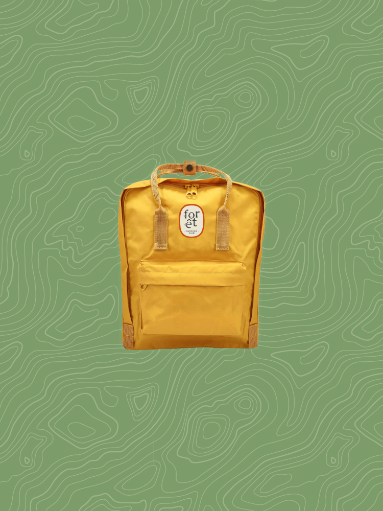A mockup of a yellow backpack with a forêt patch on it.