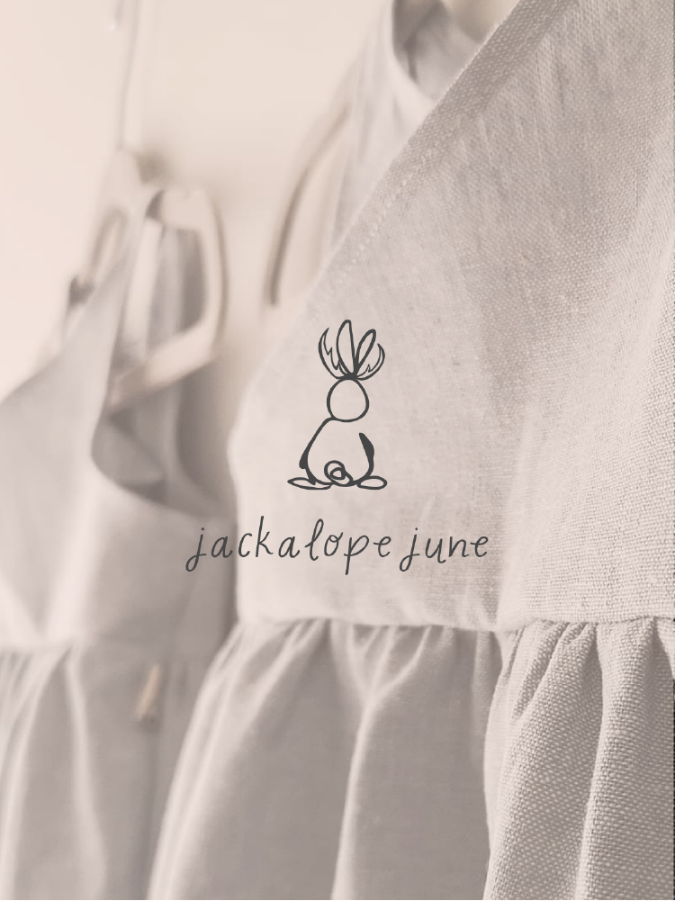 The jacklope june logo overlaid on top of a photo of a dress.