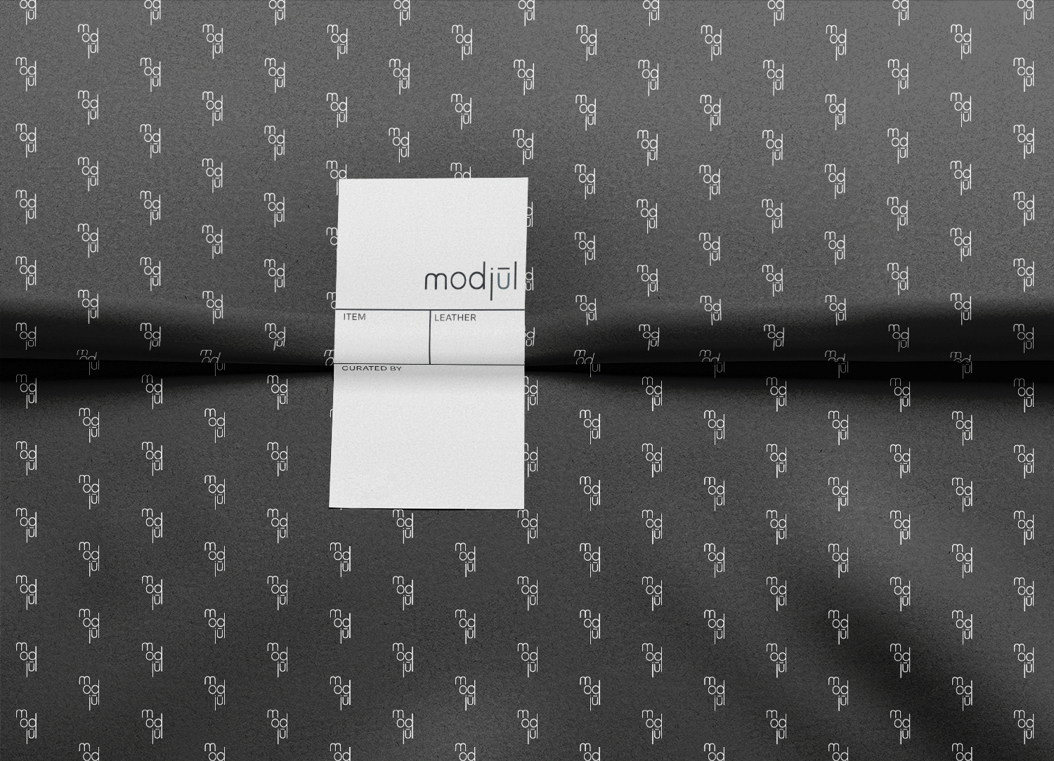 A mockup of the tissue paper and custom sticker designed for modjūl.
