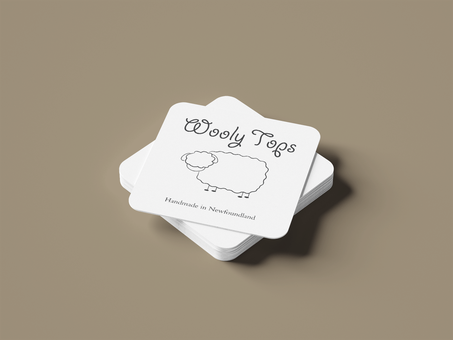A mockup of the business cards designed for Wooly Tops.